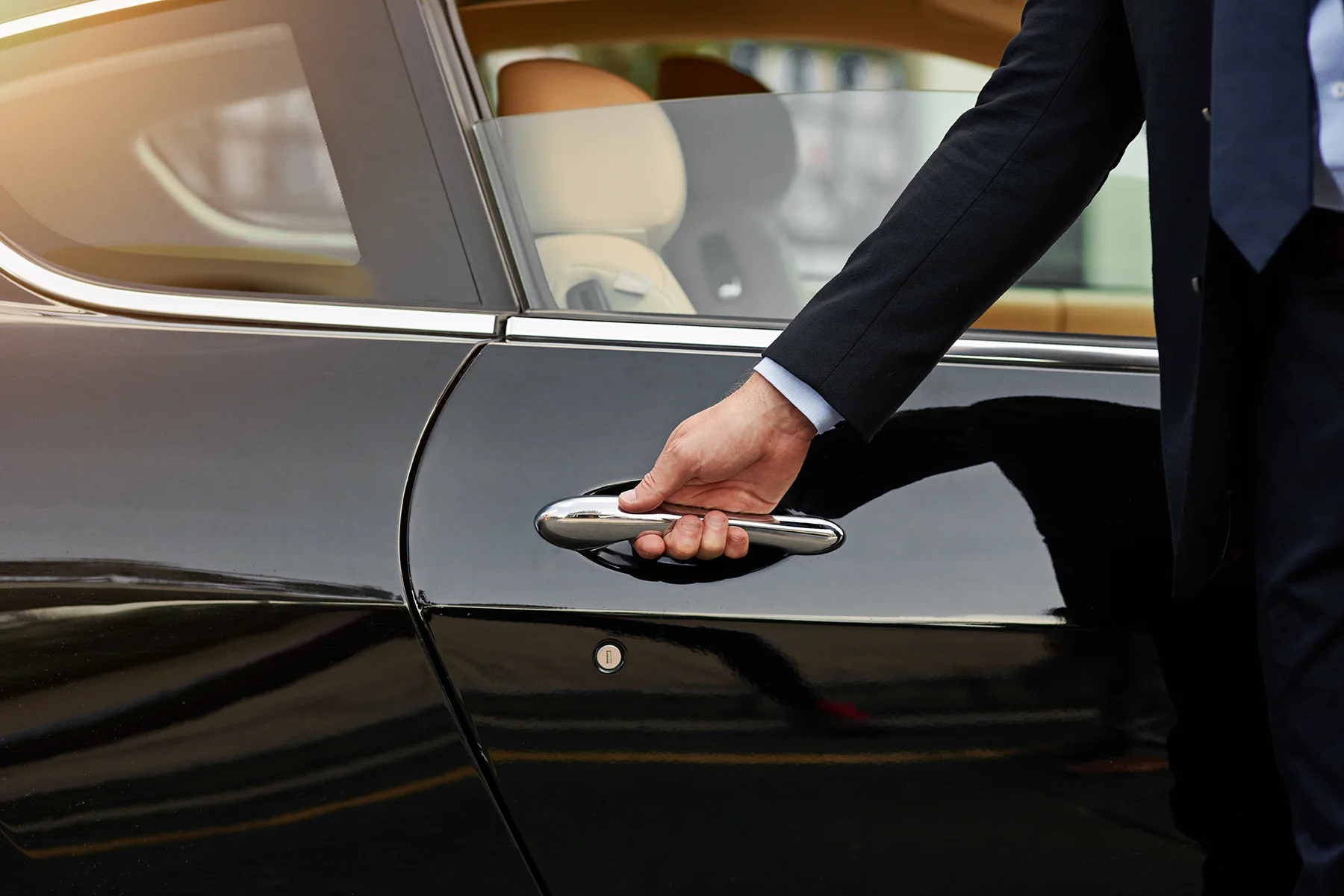Hand opening a car door as part of TEAC's Concierge Service